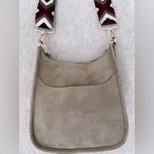 Ah-dorned suede cross body bag w/ guitar strap